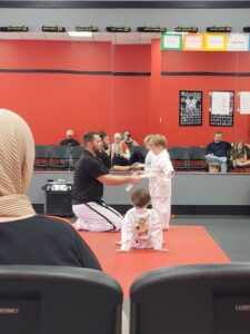 5 yr old Finn getting his white belt tied on him